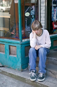 Boy sitting on street